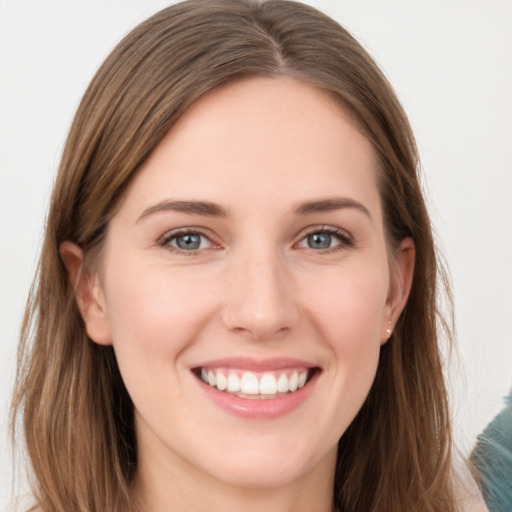 Joyful white young-adult female with long  brown hair and grey eyes