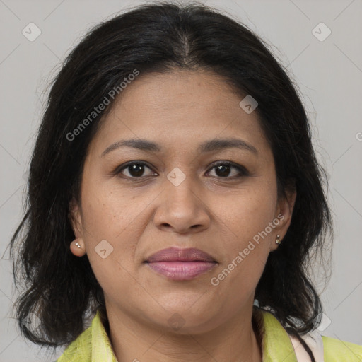 Joyful latino adult female with medium  brown hair and brown eyes
