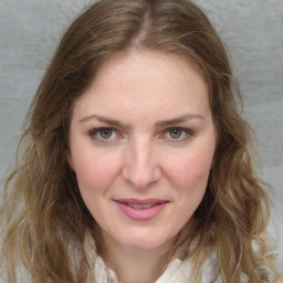 Joyful white young-adult female with medium  brown hair and green eyes