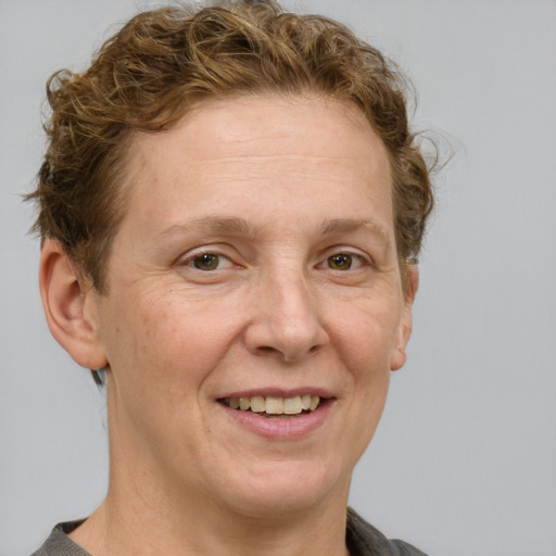 Joyful white adult female with short  brown hair and grey eyes