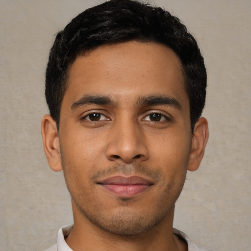 Joyful latino young-adult male with short  black hair and brown eyes