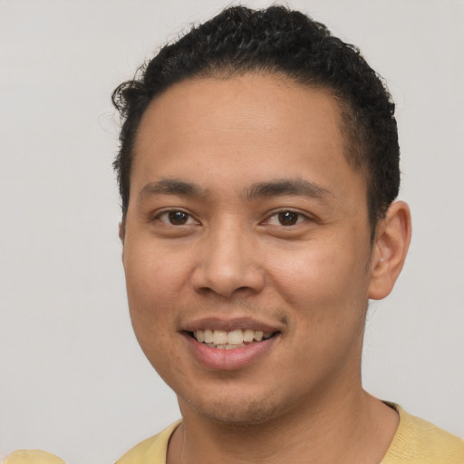 Joyful asian young-adult male with short  brown hair and brown eyes