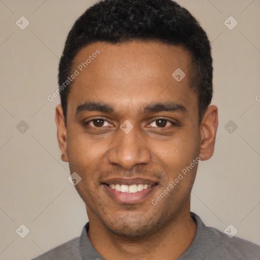 Joyful black young-adult male with short  black hair and brown eyes