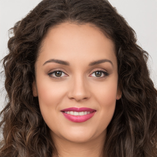 Joyful white young-adult female with long  brown hair and brown eyes