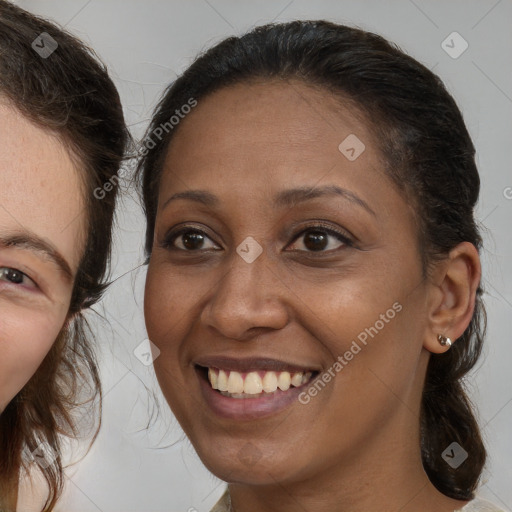 Joyful white adult female with medium  brown hair and brown eyes