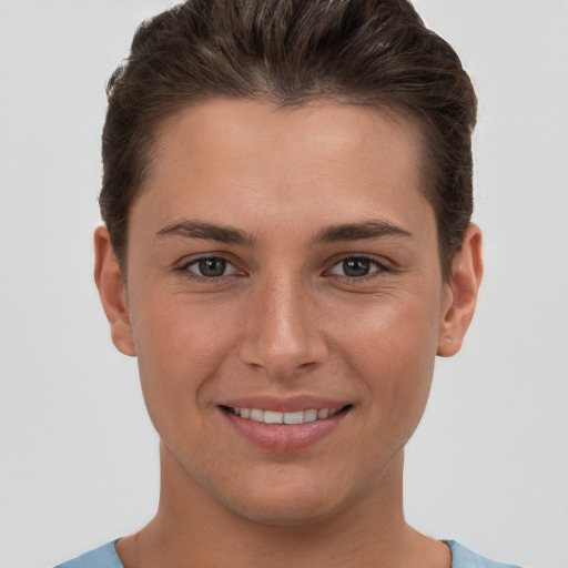 Joyful white young-adult female with short  brown hair and brown eyes