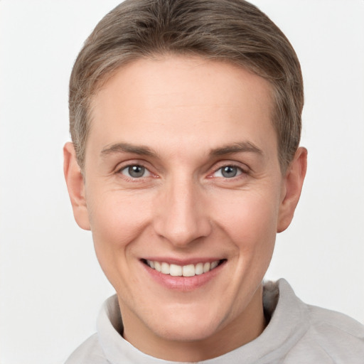 Joyful white adult male with short  brown hair and grey eyes