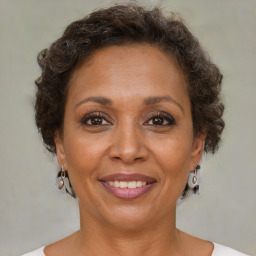 Joyful black adult female with short  brown hair and brown eyes