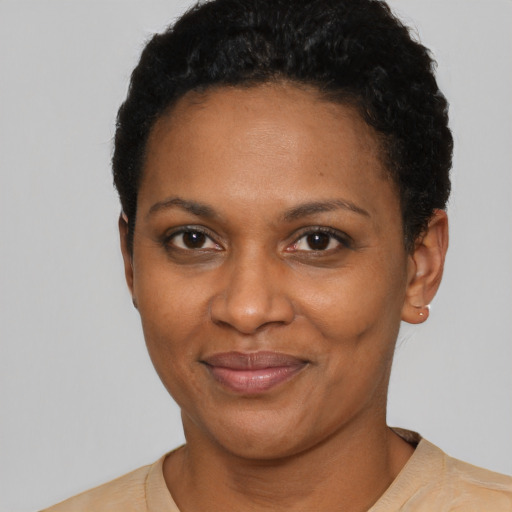 Joyful black adult female with short  black hair and brown eyes