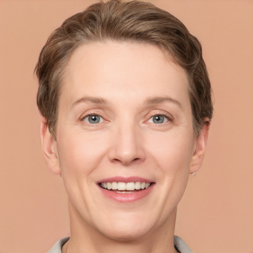 Joyful white adult female with short  brown hair and grey eyes