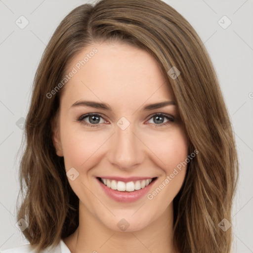 Joyful white young-adult female with long  brown hair and green eyes