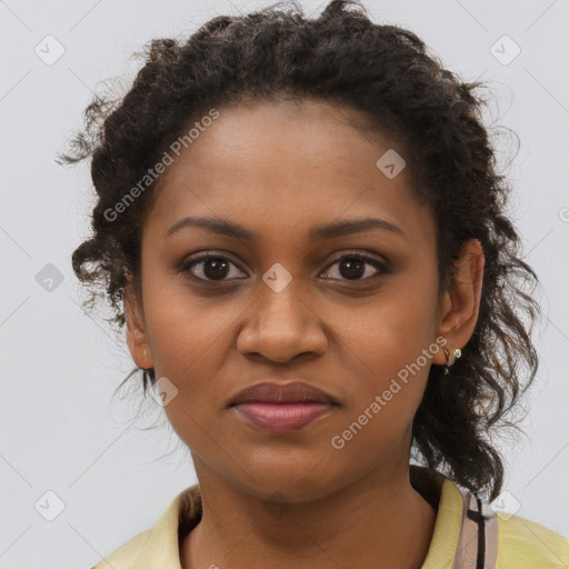 Joyful black young-adult female with long  brown hair and brown eyes