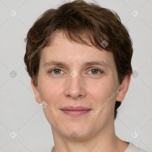 Joyful white adult male with short  brown hair and grey eyes