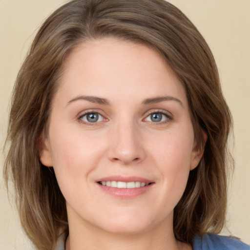 Joyful white young-adult female with medium  brown hair and blue eyes