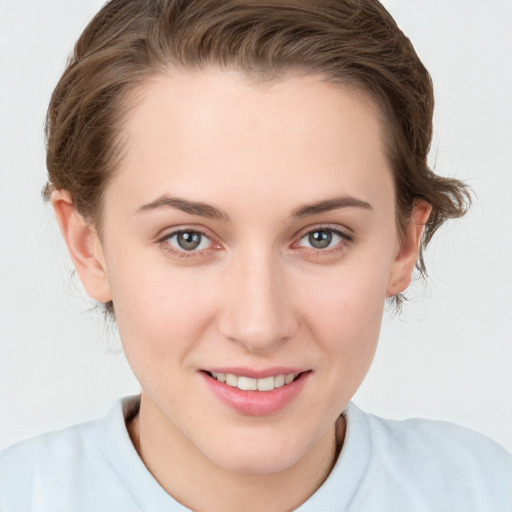 Joyful white young-adult female with short  brown hair and grey eyes