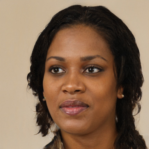 Joyful black adult female with long  black hair and brown eyes