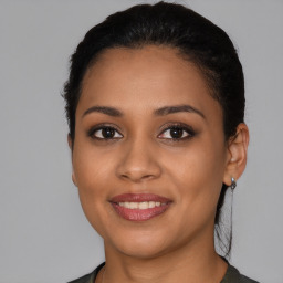 Joyful latino young-adult female with short  black hair and brown eyes