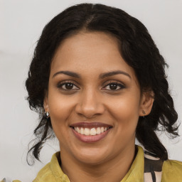 Joyful black young-adult female with medium  brown hair and brown eyes