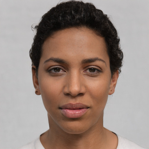 Joyful latino young-adult female with short  black hair and brown eyes