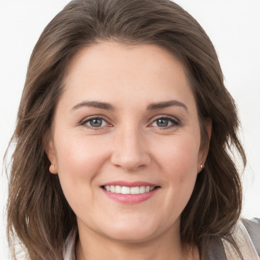 Joyful white young-adult female with long  brown hair and grey eyes