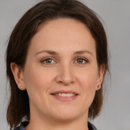 Joyful white young-adult female with medium  brown hair and grey eyes