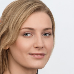 Joyful white young-adult female with long  brown hair and blue eyes