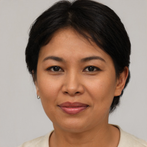 Joyful asian adult female with medium  brown hair and brown eyes