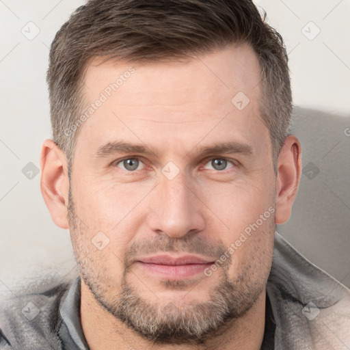 Joyful white adult male with short  brown hair and grey eyes