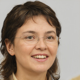 Joyful white adult female with medium  brown hair and brown eyes