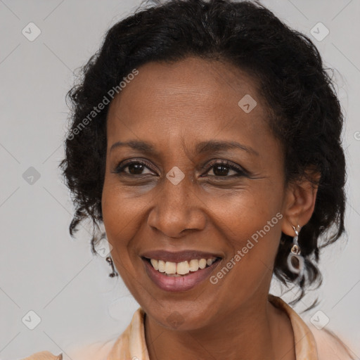 Joyful black adult female with medium  brown hair and brown eyes