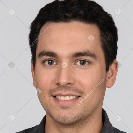 Joyful white young-adult male with short  black hair and brown eyes