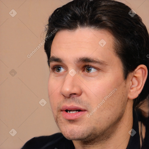 Joyful white adult male with short  black hair and brown eyes