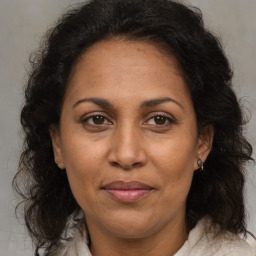 Joyful black adult female with medium  brown hair and brown eyes