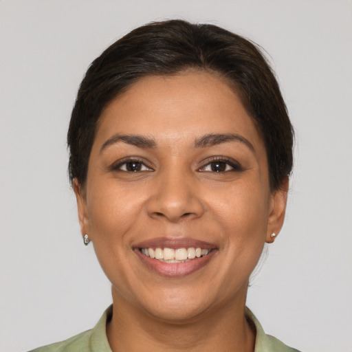 Joyful latino young-adult female with medium  brown hair and brown eyes