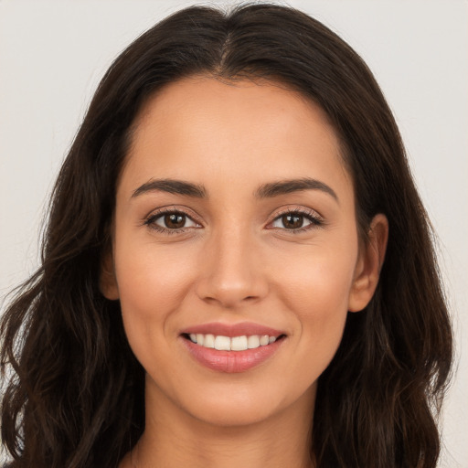 Joyful white young-adult female with long  brown hair and brown eyes