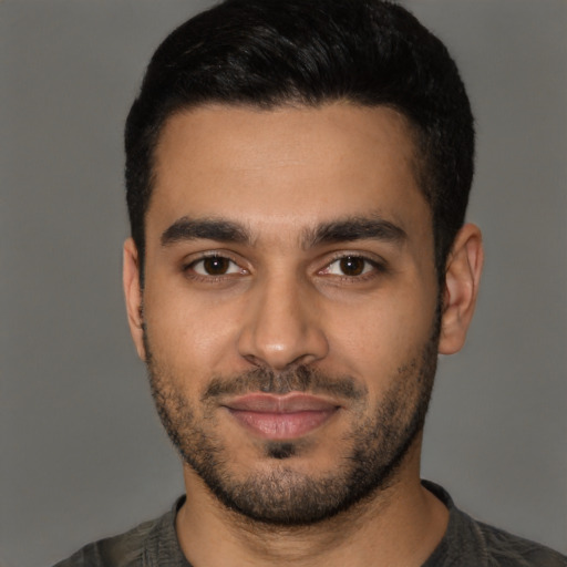 Joyful latino young-adult male with short  black hair and brown eyes