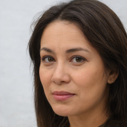 Joyful white adult female with long  brown hair and brown eyes