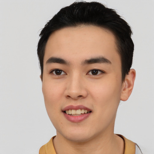 Joyful asian young-adult male with short  black hair and brown eyes
