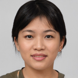 Joyful asian young-adult female with medium  brown hair and brown eyes