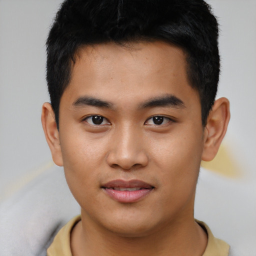 Joyful asian young-adult male with short  black hair and brown eyes