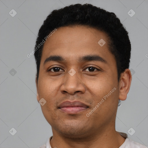 Joyful latino young-adult male with short  black hair and brown eyes