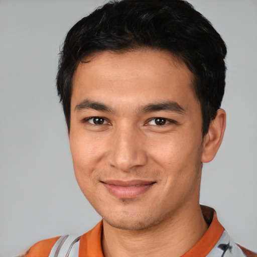 Joyful white young-adult male with short  black hair and brown eyes