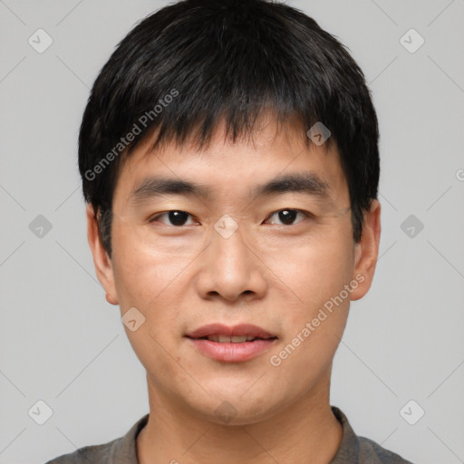 Joyful asian young-adult male with short  black hair and brown eyes