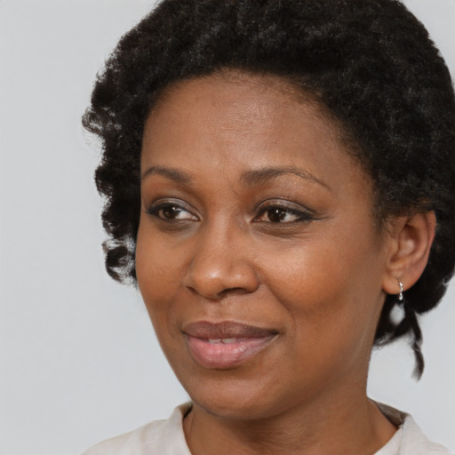 Joyful black adult female with short  brown hair and brown eyes
