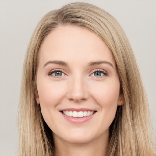 Joyful white young-adult female with long  brown hair and grey eyes