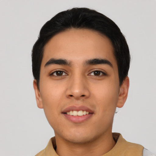 Joyful latino young-adult male with short  black hair and brown eyes