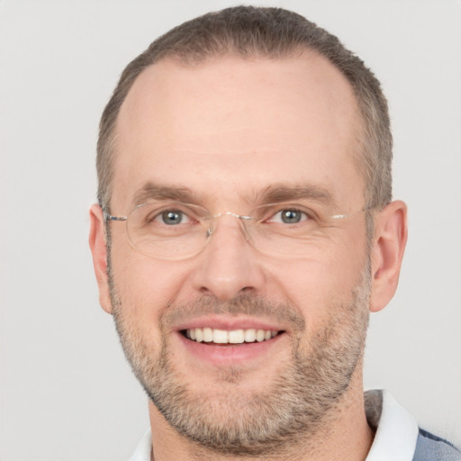 Joyful white adult male with short  brown hair and brown eyes