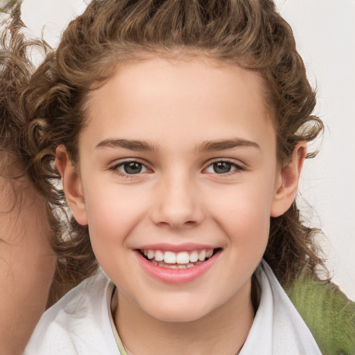 Joyful white child female with medium  brown hair and brown eyes