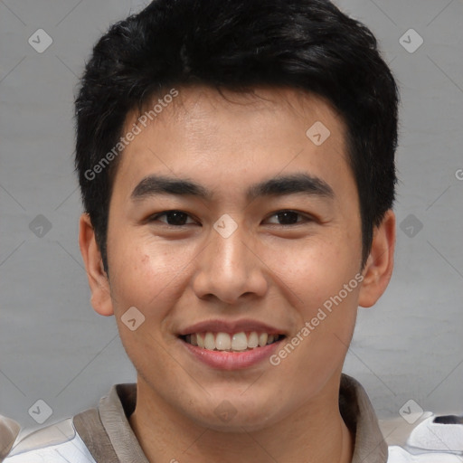 Joyful asian young-adult male with short  brown hair and brown eyes