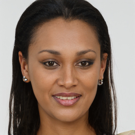 Joyful black young-adult female with long  brown hair and brown eyes